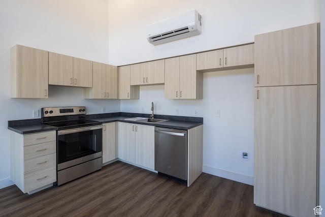 443 W Kane Creek Blvd Unit A204, Moab, UT 84532 - kitchen featuring appliances with stainless steel finishes, a sink, a wall unit AC, dark countertops, and a high ceiling