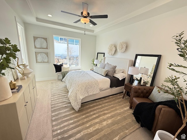 bedroom with recessed lighting, baseboards, a raised ceiling, and ceiling fan