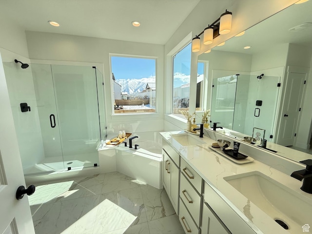 full bathroom with a sink, a garden tub, marble finish floor, and a shower stall