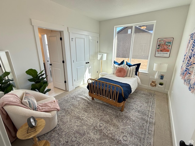 bedroom with baseboards and a closet