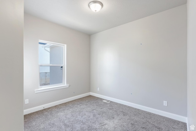 empty room with carpet and baseboards