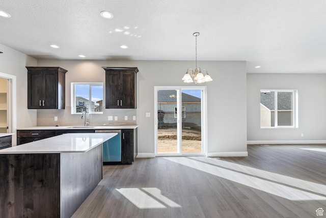 1749 S Sageberry Dr Unit 350, Santaquin, UT 84655 - kitchen with stainless steel dishwasher, a sink, light wood finished floors, dark brown cabinetry, and light countertops