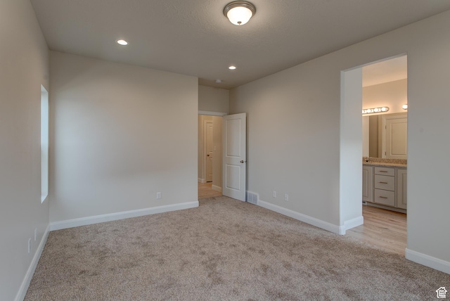 1641 S Windsong Dr Unit 371, Santaquin, UT 84655 - unfurnished bedroom with light carpet, baseboards, recessed lighting, and connected bathroom