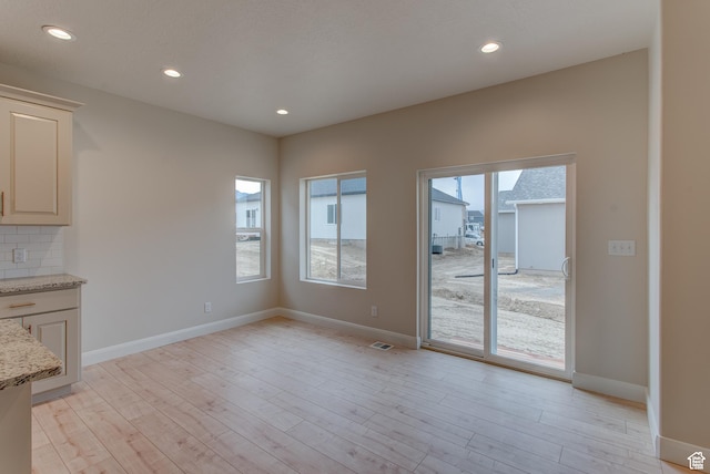 1641 S Windsong Dr Unit 371, Santaquin, UT 84655 - unfurnished dining area with light wood-style floors, recessed lighting, and baseboards
