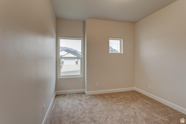 1641 S Windsong Dr Unit 371, Santaquin, UT 84655 - empty room featuring light carpet, plenty of natural light, and baseboards