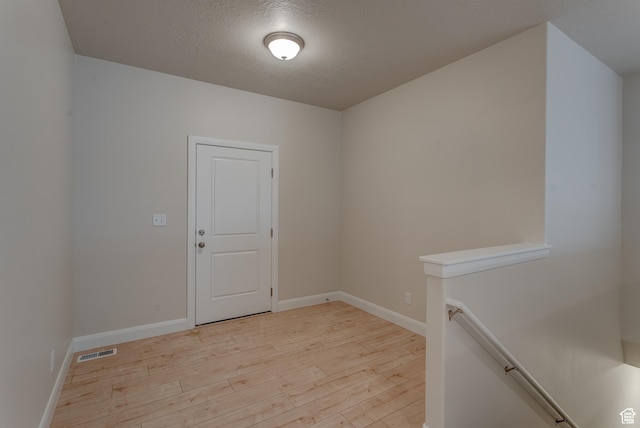 1641 S Windsong Dr Unit 371, Santaquin, UT 84655 - spare room with light wood-style flooring, baseboards, and a textured ceiling