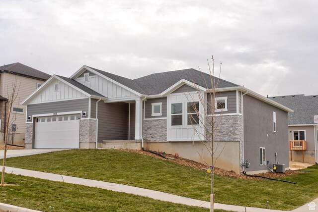 1641 S Windsong Dr Unit 371, Santaquin, UT 84655 - view of front facade with board and batten siding, stone siding, a garage, concrete driveway, and a front yard