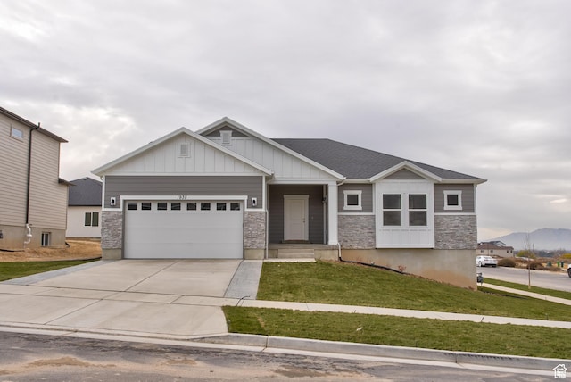 1641 S Windsong Dr Unit 371, Santaquin, UT 84655 - craftsman house with an attached garage, driveway, board and batten siding, a front yard, and stone siding