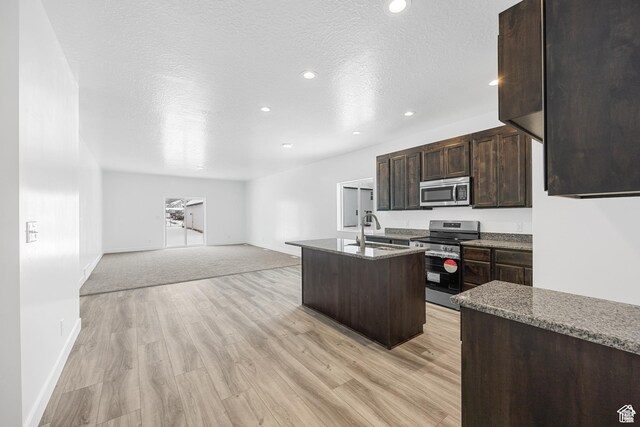 1701 S Windsong Dr Unit 377, Santaquin, UT 84655 - kitchen featuring stainless steel appliances, a center island with sink, light wood-type flooring, and sink