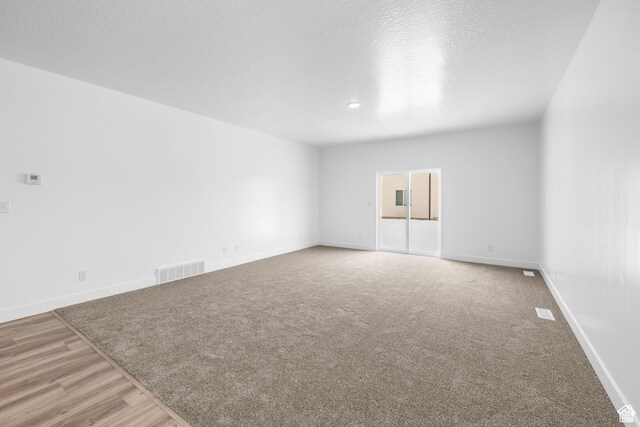 1701 S Windsong Dr Unit 377, Santaquin, UT 84655 - unfurnished room with wood-type flooring and a textured ceiling