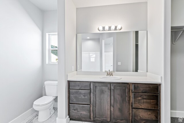 1781 S Windsong Dr Unit 384, Santaquin, UT 84655 - bathroom with toilet, baseboards, vanity, and marble finish floors
