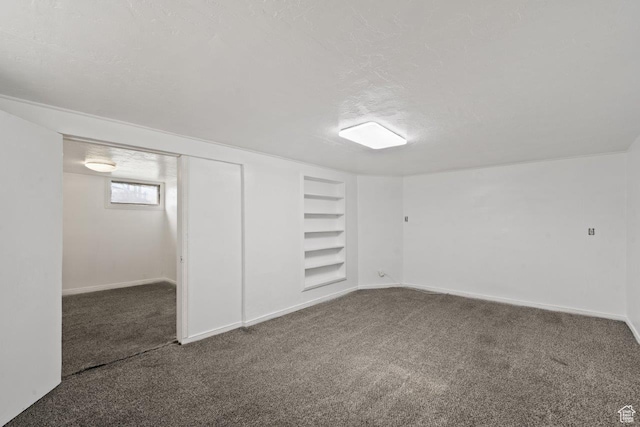37 N Lakeview Dr, Clearfield, UT 84015 - below grade area featuring built in features, a textured ceiling, baseboards, and carpet