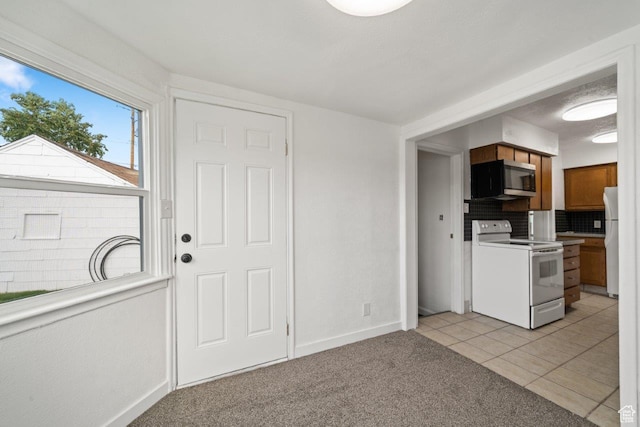 37 N Lakeview Dr, Clearfield, UT 84015 - kitchen with light colored carpet, white appliances, light tile patterned floors, baseboards, and brown cabinets