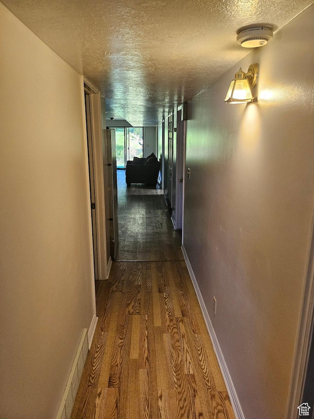 4180 Liberty Ave, South Ogden, UT 84403 - hall with visible vents, baseboards, a textured ceiling, and dark wood-style floors