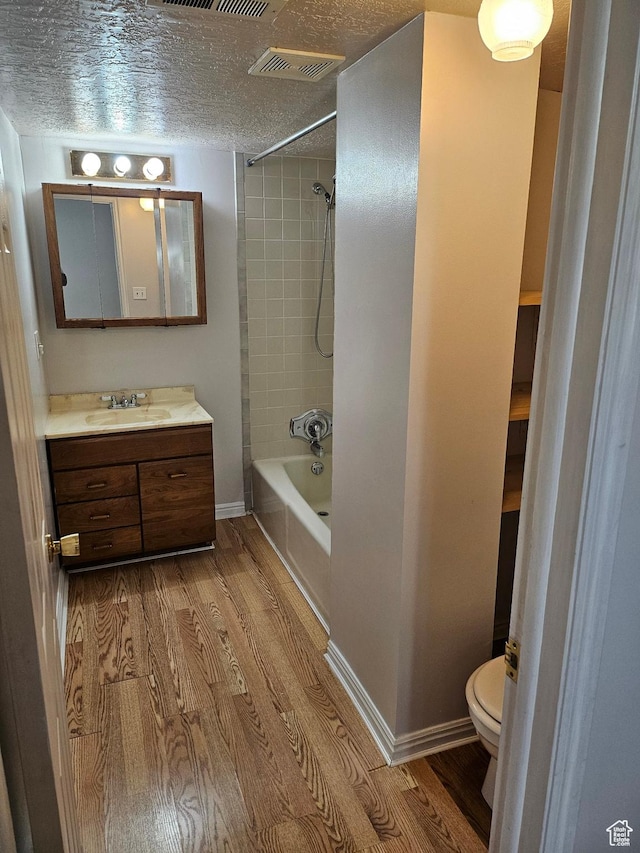 4180 Liberty Ave, South Ogden, UT 84403 - bathroom featuring visible vents, vanity, wood finished floors, and a textured ceiling