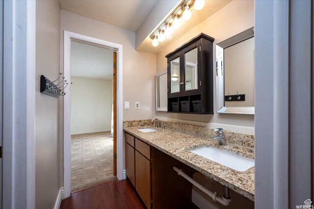 4180 Liberty Ave, South Ogden, UT 84403 - bathroom with a sink, baseboards, double vanity, and wood finished floors