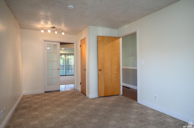 4180 Liberty Ave, South Ogden, UT 84403 - spare room featuring a textured ceiling, carpet flooring, and baseboards