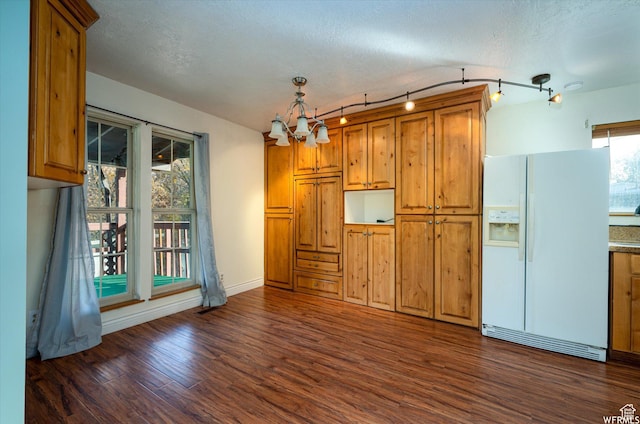 4180 Liberty Ave, South Ogden, UT 84403 - kitchen featuring baseboards, an inviting chandelier, white fridge with ice dispenser, dark wood finished floors, and brown cabinets
