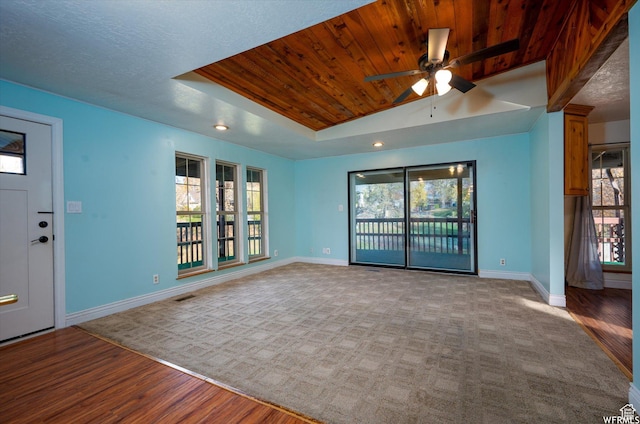 4180 Liberty Ave, South Ogden, UT 84403 - unfurnished living room featuring baseboards, a raised ceiling, wooden ceiling, a ceiling fan, and wood finished floors