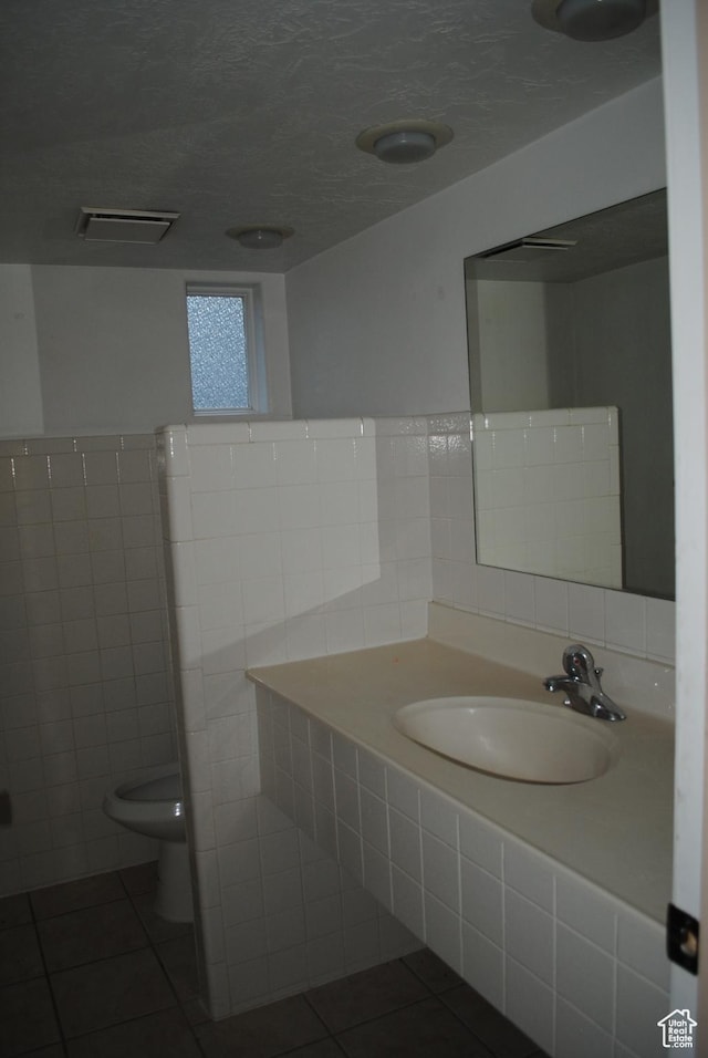 619 E 400 N, Logan, UT 84321 - bathroom featuring visible vents, toilet, vanity, tile patterned floors, and a textured ceiling