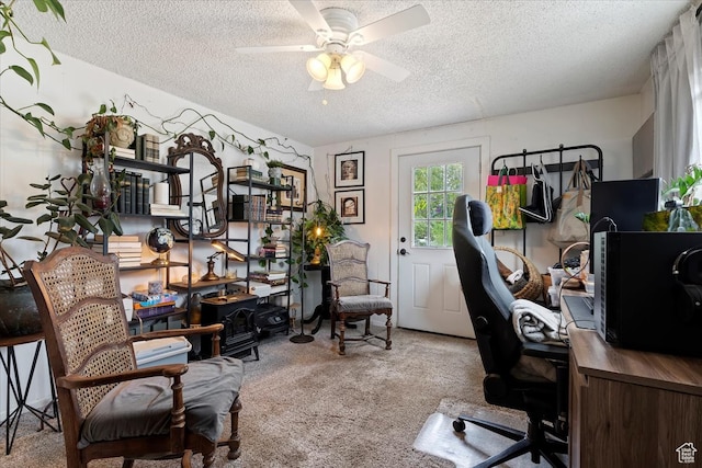 office with ceiling fan, a textured ceiling, and light carpet
