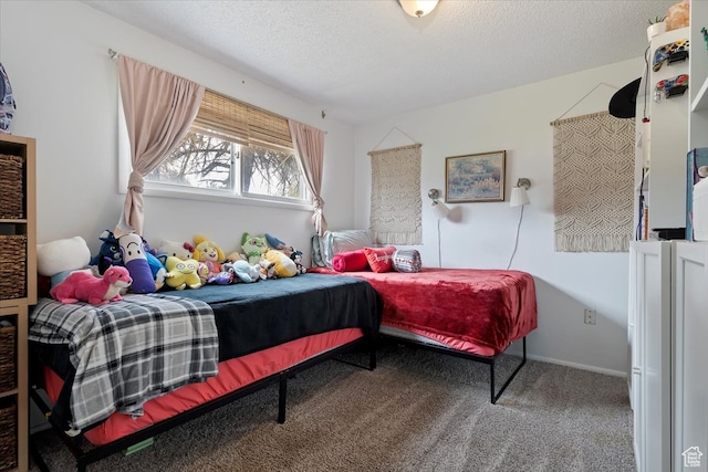 bedroom with carpet floors and a textured ceiling