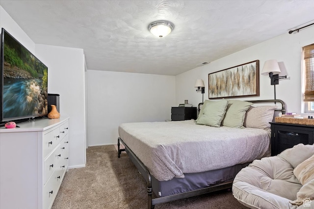 carpeted bedroom featuring a textured ceiling