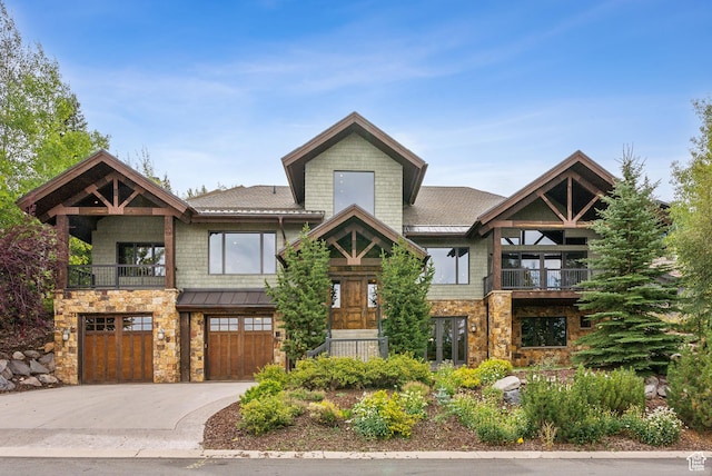 3608 Sun Ridge Dr, Park City, UT 84060 - craftsman inspired home featuring concrete driveway, a balcony, stone siding, a standing seam roof, and an attached garage