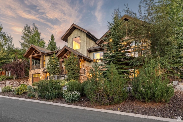 3608 Sun Ridge Dr, Park City, UT 84060 - view of front facade featuring a garage, stone siding, and a balcony