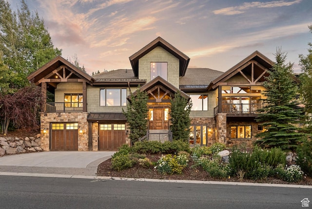 3608 Sun Ridge Dr, Park City, UT 84060 - view of front of property featuring a standing seam roof, a garage, driveway, stone siding, and a balcony