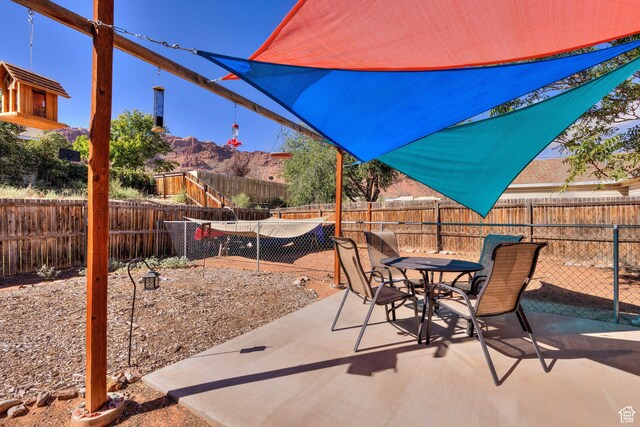 1122 E Holyoak Ln, Moab, UT 84532 - view of patio / terrace with a mountain view, outdoor dining space, and a fenced backyard