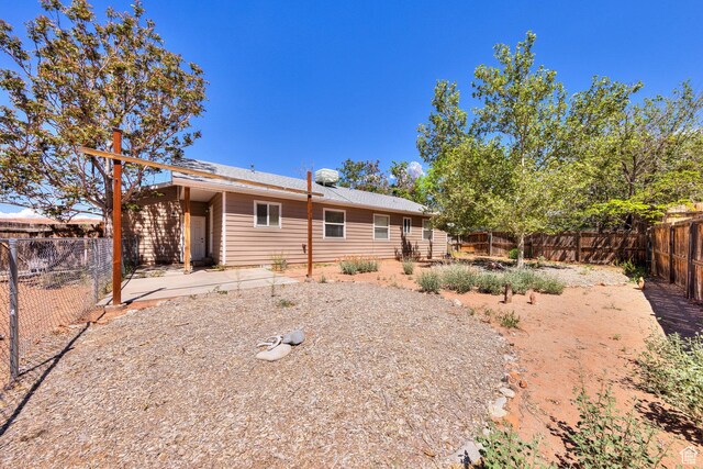 1122 E Holyoak Ln, Moab, UT 84532 - back of house featuring a fenced backyard and a patio area