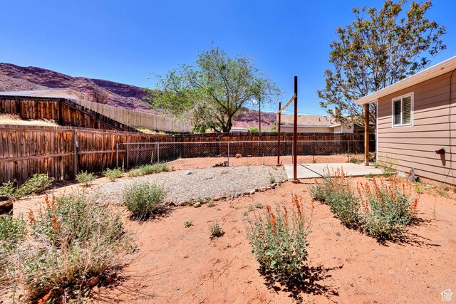 1122 E Holyoak Ln, Moab, UT 84532 - view of yard featuring a fenced backyard, a patio, and a mountain view