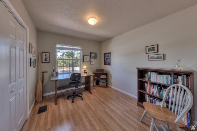 1122 E Holyoak Ln, Moab, UT 84532 - home office with baseboards, visible vents, and wood finished floors