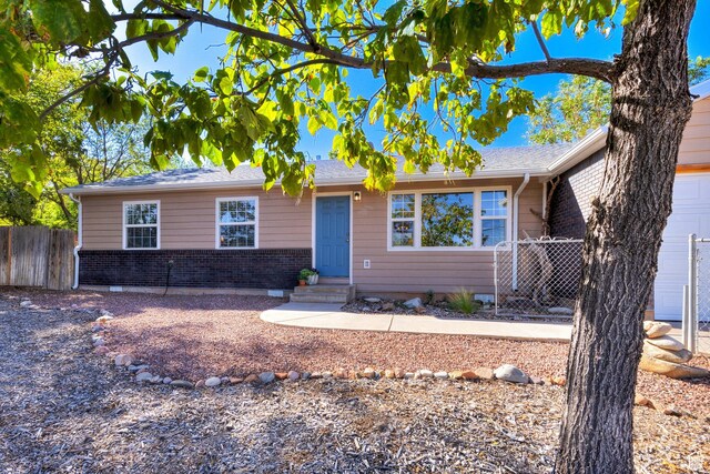 1122 E Holyoak Ln, Moab, UT 84532 - single story home featuring brick siding, fence, and entry steps