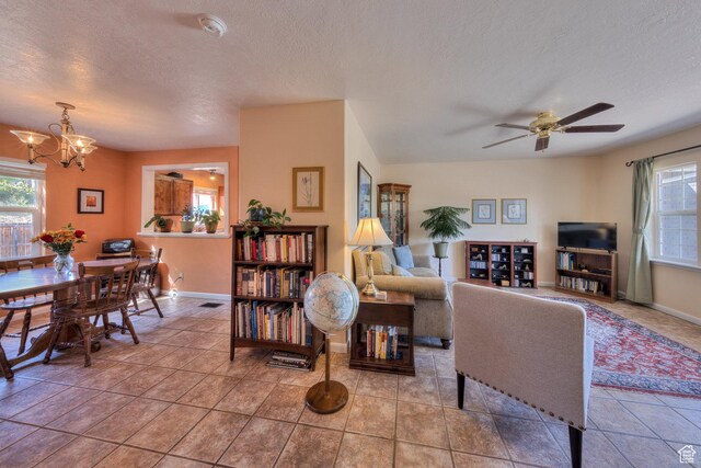 1122 E Holyoak Ln, Moab, UT 84532 - living area with a textured ceiling, baseboards, and ceiling fan with notable chandelier