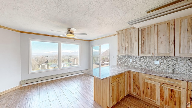 410 S Woodland Hills Dr, Woodland Hills, UT 84653 - kitchen featuring light brown cabinetry, ceiling fan, light wood-style flooring, a peninsula, and baseboard heating