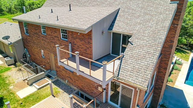 410 S Woodland Hills Dr, Woodland Hills, UT 84653 - rear view of property with board and batten siding, brick siding, a shingled roof, and a wooden deck
