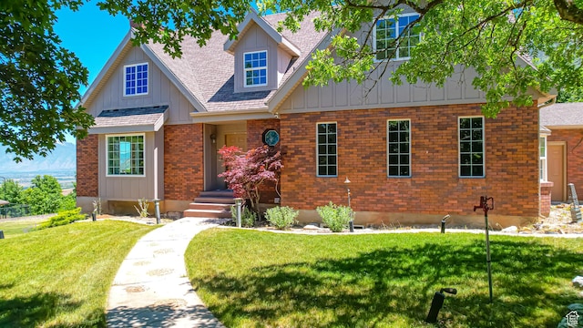 410 S Woodland Hills Dr, Woodland Hills, UT 84653 - view of front of house featuring a front lawn, brick siding, board and batten siding, and roof with shingles