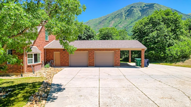 410 S Woodland Hills Dr, Woodland Hills, UT 84653 - view of front of property featuring driveway, brick siding, a mountain view, and an attached garage