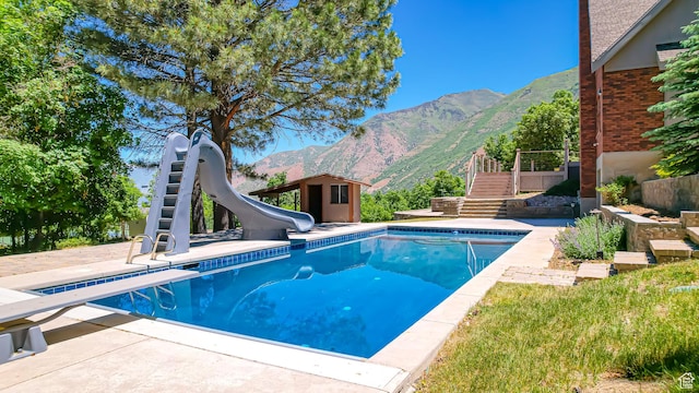 410 S Woodland Hills Dr, Woodland Hills, UT 84653 - pool featuring stairway, a diving board, a water slide, an outbuilding, and a mountain view