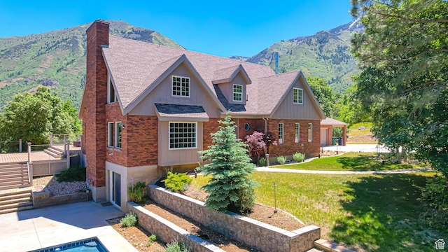 410 S Woodland Hills Dr, Woodland Hills, UT 84653 - view of front of house featuring driveway, a front yard, roof with shingles, brick siding, and a garage