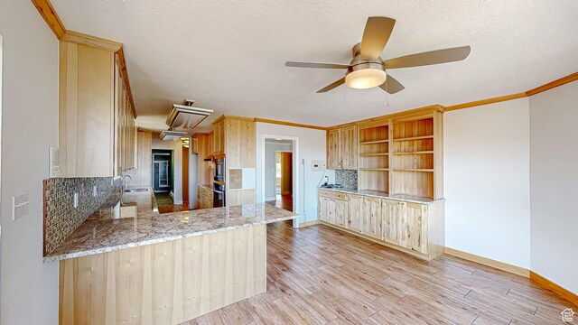 410 S Woodland Hills Dr, Woodland Hills, UT 84653 - kitchen featuring light wood finished floors, ceiling fan, tasteful backsplash, light brown cabinets, and a sink