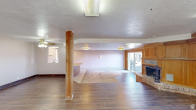 410 S Woodland Hills Dr, Woodland Hills, UT 84653 - unfurnished living room featuring baseboards, ceiling fan, a brick fireplace, visible vents, and wood finished floors