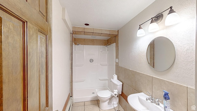 410 S Woodland Hills Dr, Woodland Hills, UT 84653 - full bathroom with a stall shower, toilet, a textured ceiling, tile patterned flooring, and tile walls