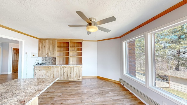 410 S Woodland Hills Dr, Woodland Hills, UT 84653 - kitchen featuring light wood finished floors, baseboard heating, crown molding, and light brown cabinetry
