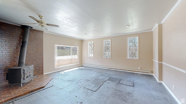 410 S Woodland Hills Dr, Woodland Hills, UT 84653 - unfurnished living room featuring a wealth of natural light, a wood stove, ceiling fan, and a baseboard radiator