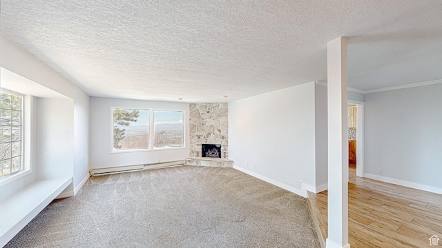 410 S Woodland Hills Dr, Woodland Hills, UT 84653 - unfurnished living room with baseboard heating, baseboards, a textured ceiling, a fireplace, and wood finished floors