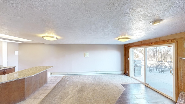 410 S Woodland Hills Dr, Woodland Hills, UT 84653 - unfurnished room featuring light tile patterned flooring, a baseboard heating unit, and a textured ceiling