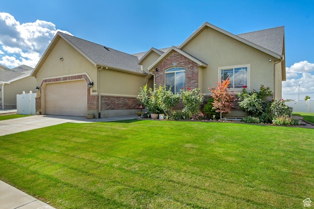 1052 S 350 E, Payson, UT 84651 - view of front of home featuring stucco siding, an attached garage, driveway, and a front lawn